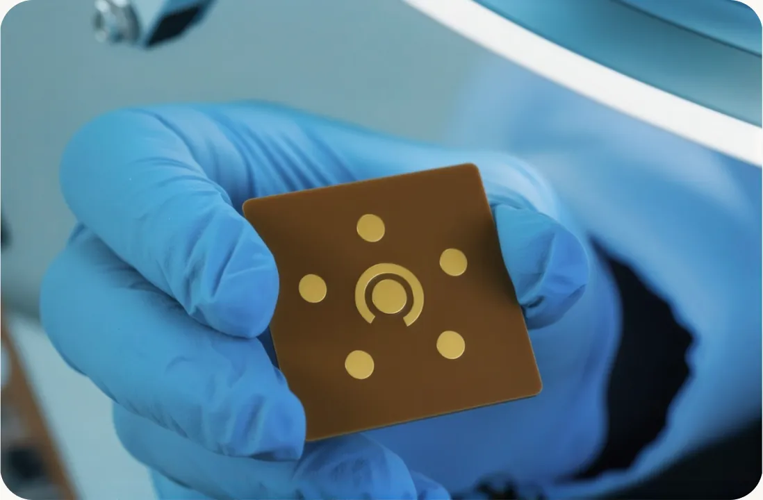 Gloved hand holding a sensor chip