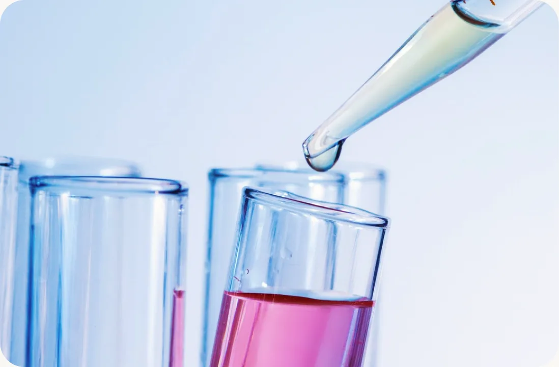 Pipette dropping a sample into test tubes